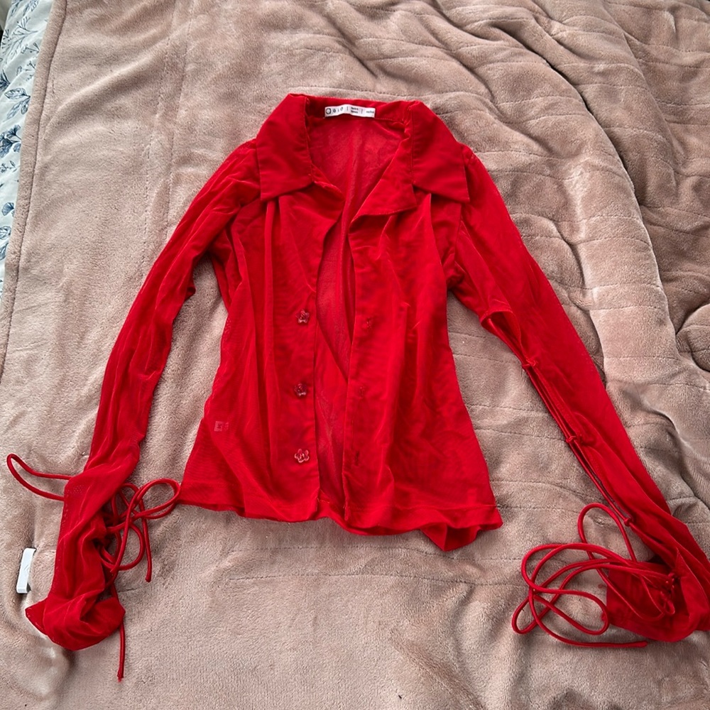 AEIE Studios is red mesh button up with tie up sleeves